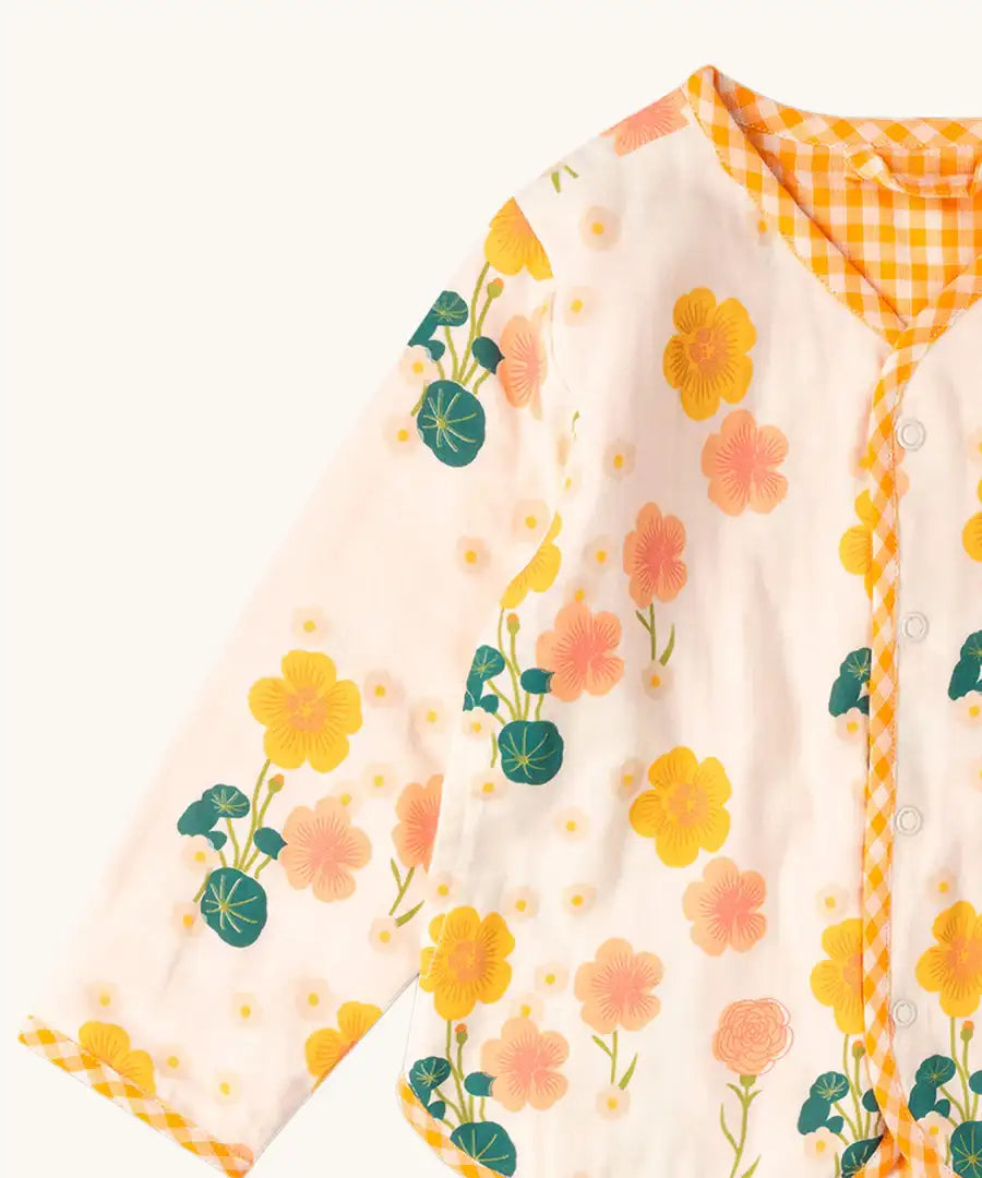 Close up of the Little Green Radicals children's Flora Reversible Spring Jacket in cream with yellow gold gingham print edging. 