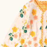 Close up of the Little Green Radicals children's Flora Reversible Spring Jacket in cream with yellow gold gingham print edging. 