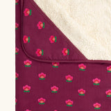 Close up of the hood on the Little Green Radicals pink flowers organic cotton sherpa hooded baby blanket.