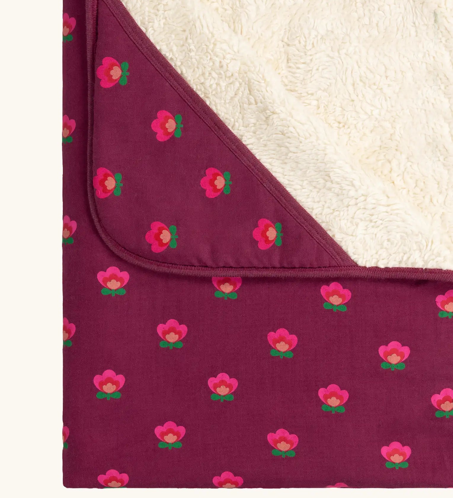 Close up of the hood on the Little Green Radicals pink flowers organic cotton sherpa hooded baby blanket.