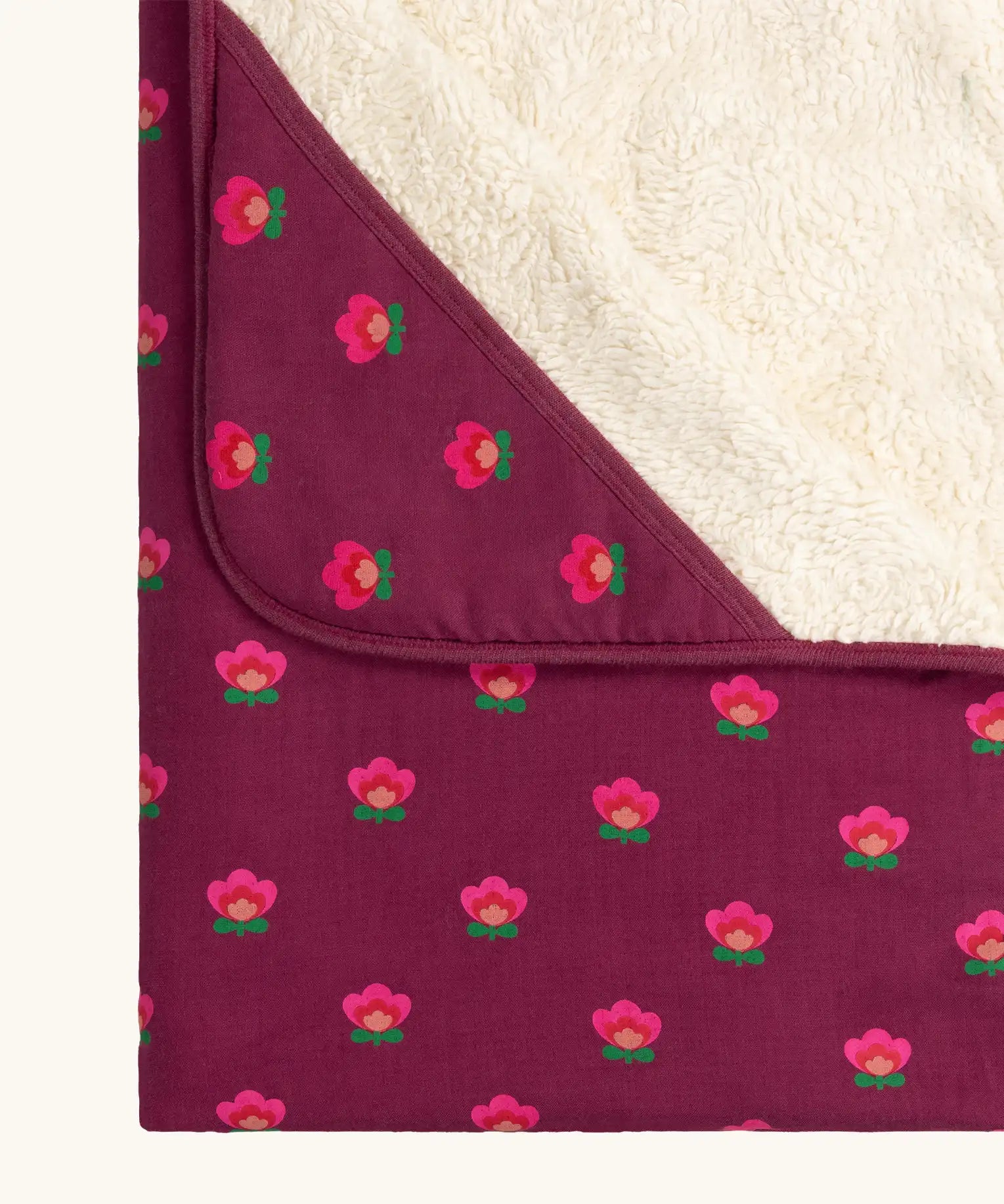 Close up of the hood on the Little Green Radicals pink flowers organic cotton sherpa hooded baby blanket.