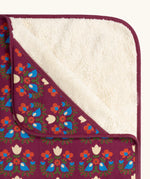 Close up of the Little Green Radicals folk bird organic cotton hooded baby blanket with sherpa fleece lining.