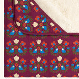 Close up of the Little Green Radicals folk bird organic cotton hooded baby blanket with sherpa fleece lining.