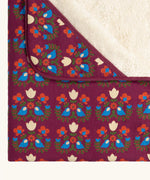 Close up of the Little Green Radicals folk bird organic cotton hooded baby blanket with sherpa fleece lining.