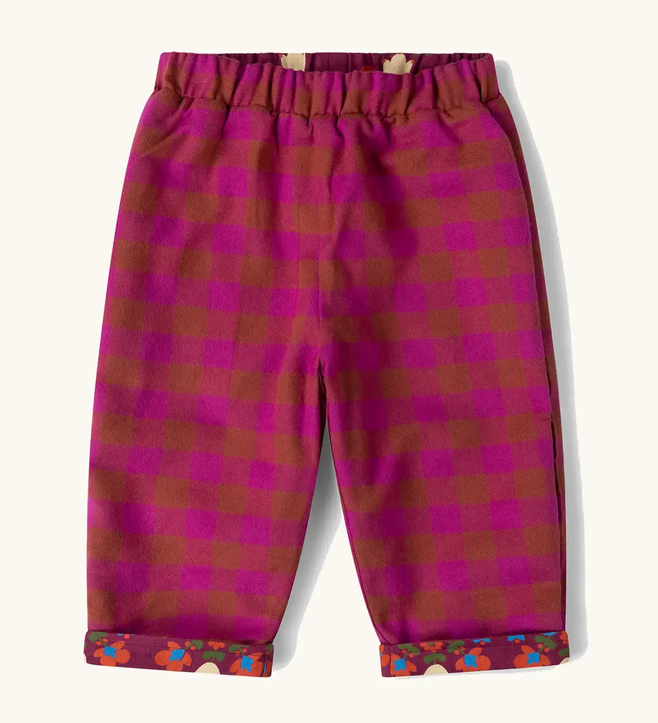 Little Green Radicals folk birds organic cotton reversible pull on trousers shown on the pink check side.