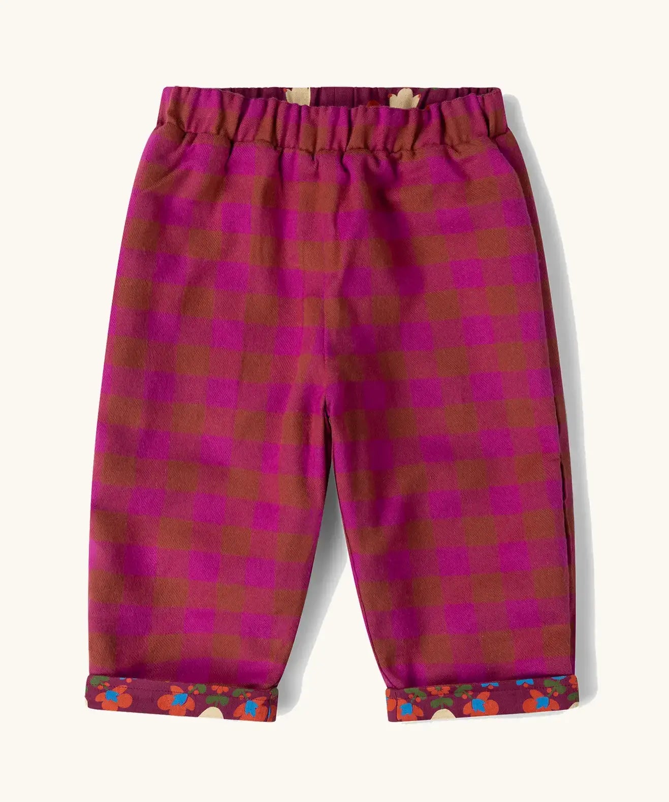 Little Green Radicals folk birds organic cotton reversible pull on trousers shown on the pink check side.