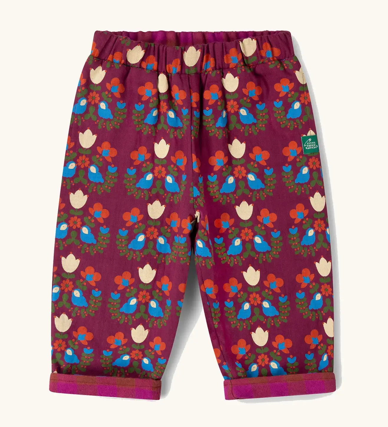Little Green Radicals folk birds organic cotton reversible pull on trousers. Deep pink background with a repeat bird and flower print.