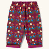 Little Green Radicals folk birds organic cotton reversible pull on trousers. Deep pink background with a repeat bird and flower print.