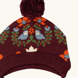 Little Green Radicals folk birds knitted purple bobble hat, close up showing the details on the design