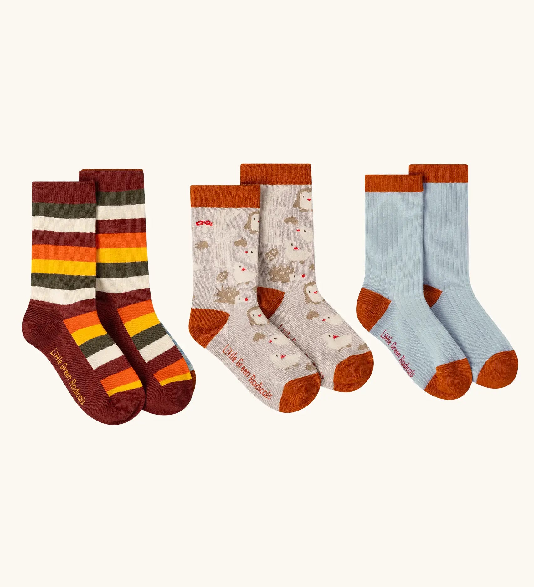 Little Green Radicals folk tales ankle socks in a 3 pack. One rainbow stripe, one fol tales and one light blue pair.