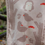 Close up of the design on the Little Green Radicals cream folk tales knitted organic cotton baby blanket.