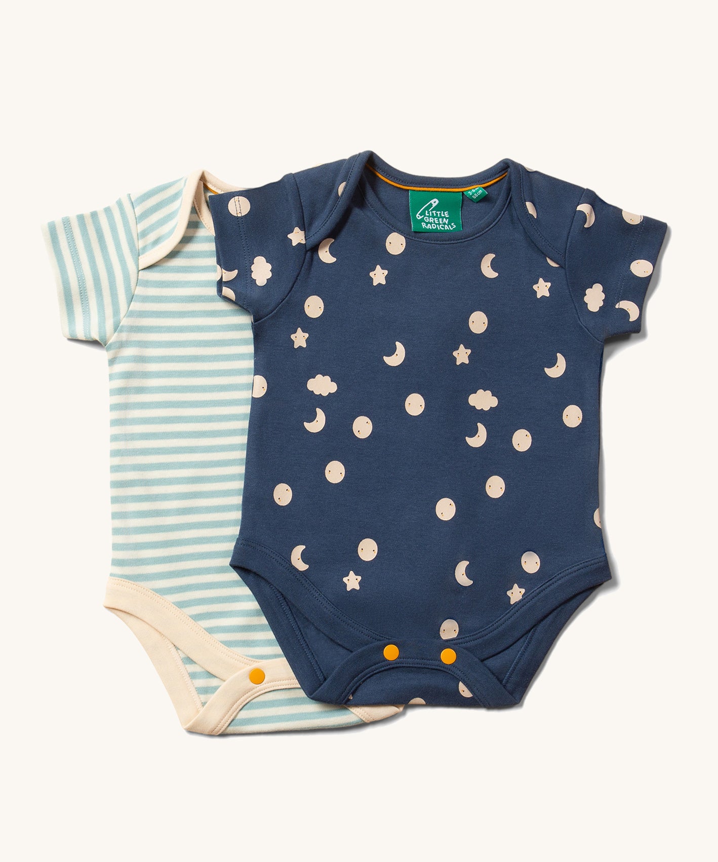 The Little Green Radicals Full Moon Organic Cotton Baby Body Set on a plain background. One body suit has a moon and cloud print on a blue background the second has a cream and blue striped design. 