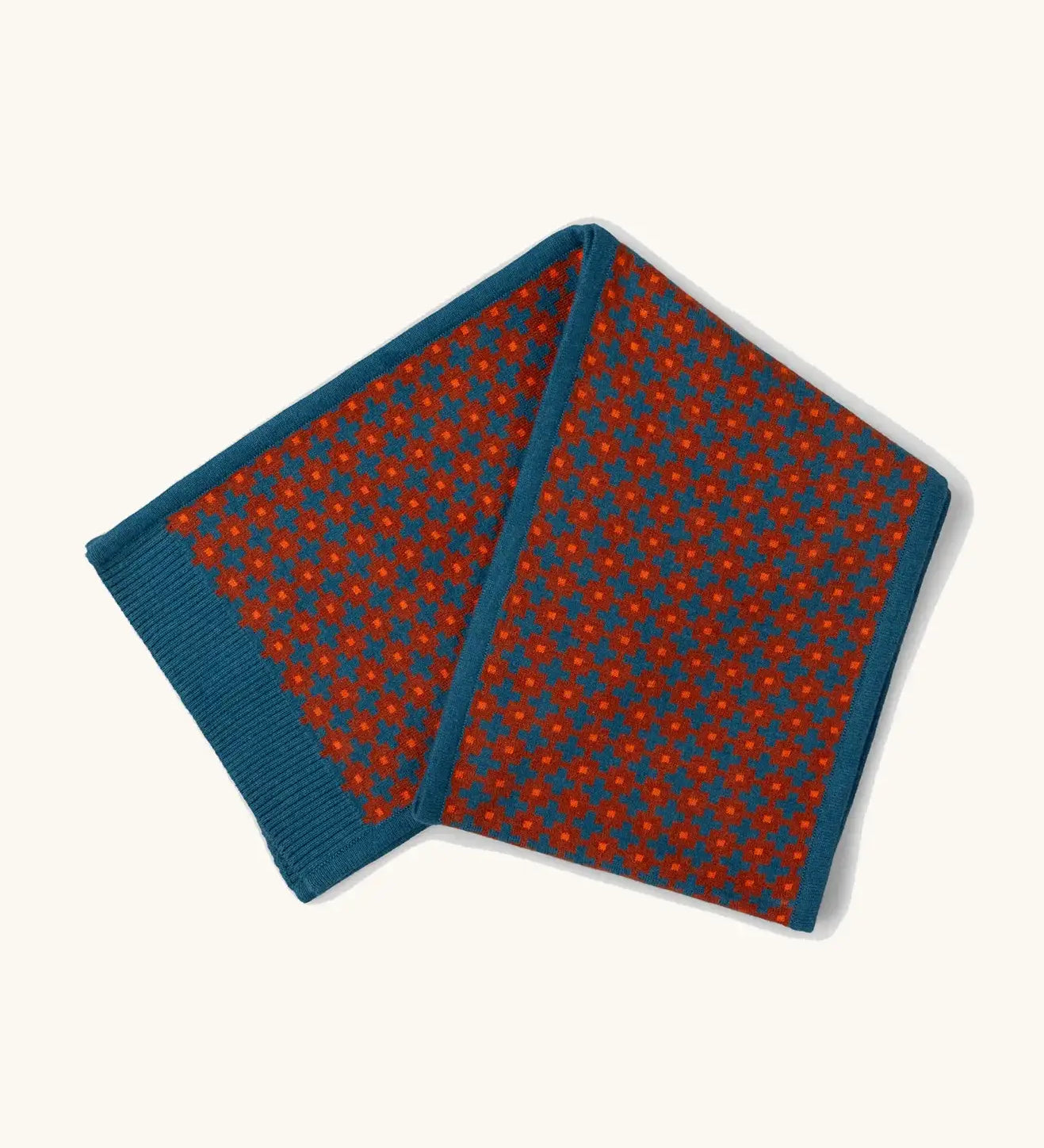 Little Green Radicals ginger squares design knitted scarf. Blue with ginger red squares pattern over it.