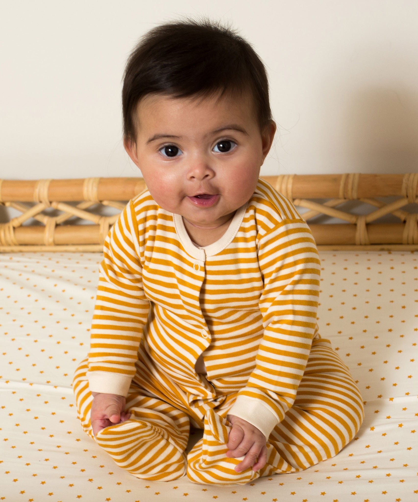 Little Green Radicals Organic 2 Pack Baby Body Set - a baby wearing the yellow gold striped babygrow. 