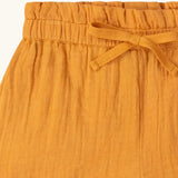 Close up of the waistband on the Little Green Radicals golden ochre yellow kids shorts organic cotton shorts.