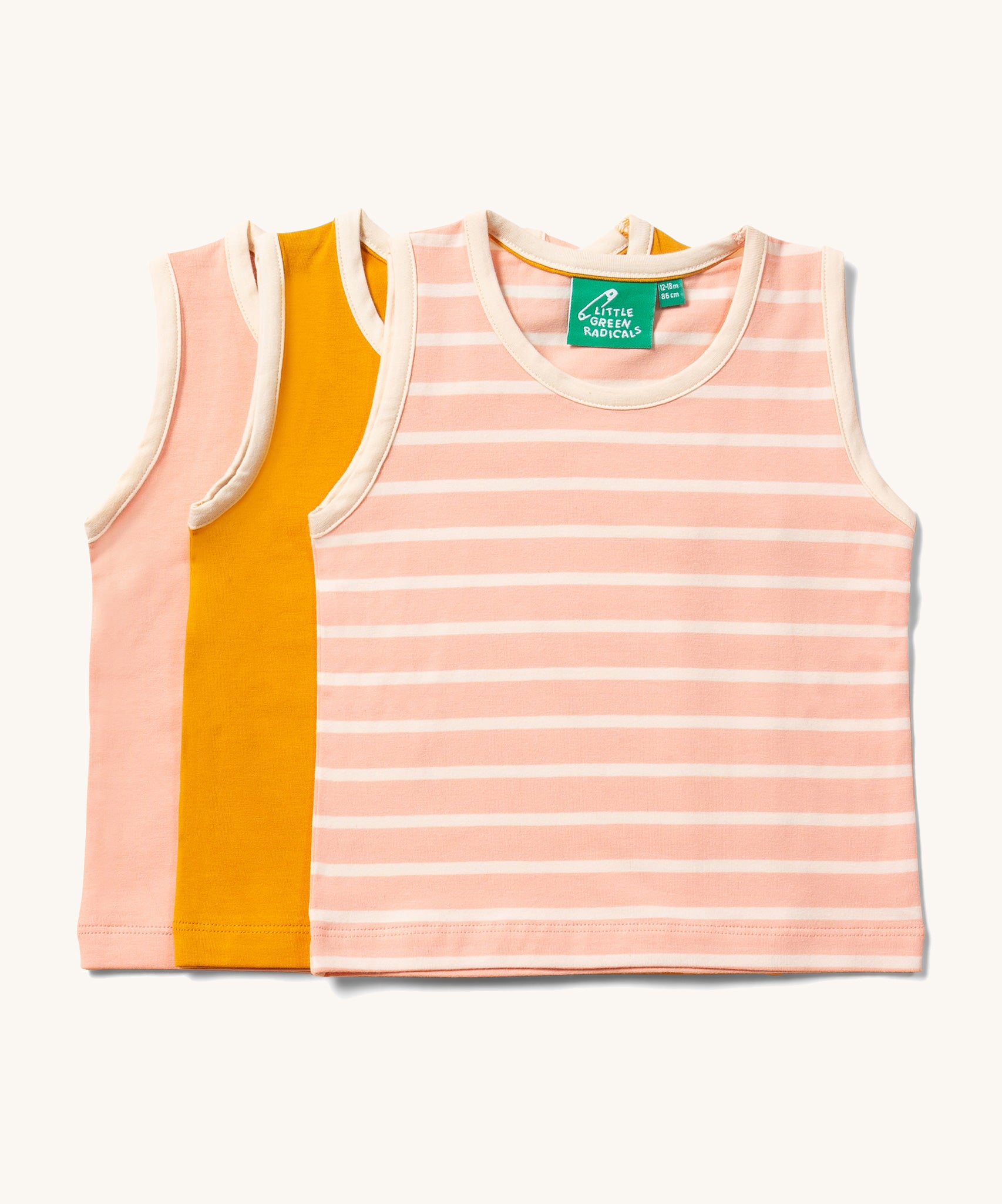 Little Green Radicals Organic Cotton sleeveless Vest Set in a 3 pack. One  has pink and cream stripes, one is plain yellow gold and one is plain pink.