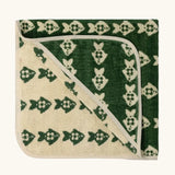 Little Green Radicals GOTS organic cotton hooded towel in green and cream with a repeating fish design folded into a square