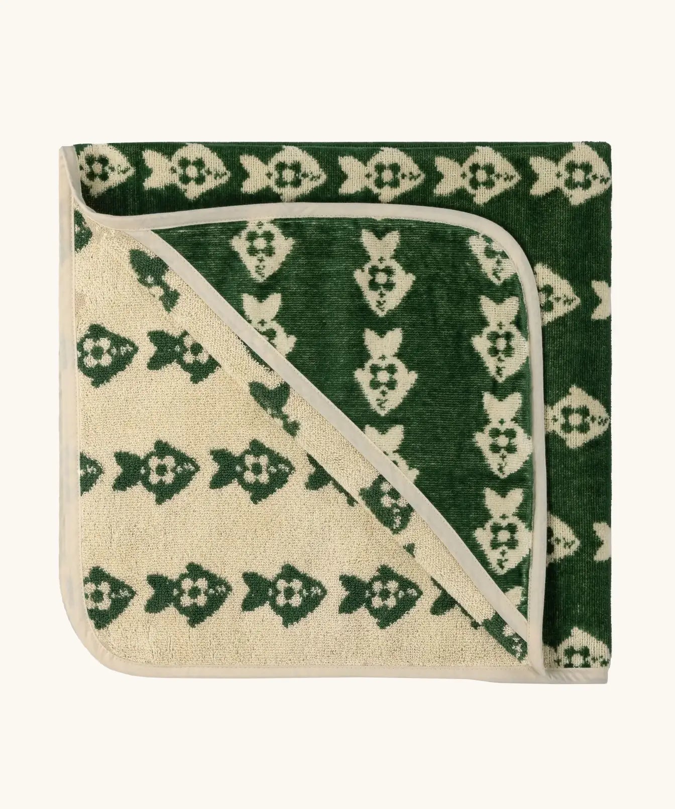 Little Green Radicals GOTS organic cotton hooded towel in green and cream with a repeating fish design folded into a square