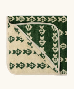 Little Green Radicals GOTS organic cotton hooded towel in green and cream with a repeating fish design folded into a square