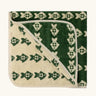 Little Green Radicals GOTS organic cotton hooded towel in green and cream with a repeating fish design folded into a square