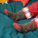 A close up of the winter rabbits design socks on a child's feet. Little Green Radicals Ankle Socks 3 Pack - Winter Rabbits. The organic cotton children's socks are a part of a wide range of organic cotton clothing for children available here at Babipur. 