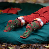 A close up of the winter rabbits design socks on a child's feet. Little Green Radicals Ankle Socks 3 Pack - Winter Rabbits. The organic cotton children's socks are a part of a wide range of organic cotton clothing for children available here at Babipur. 