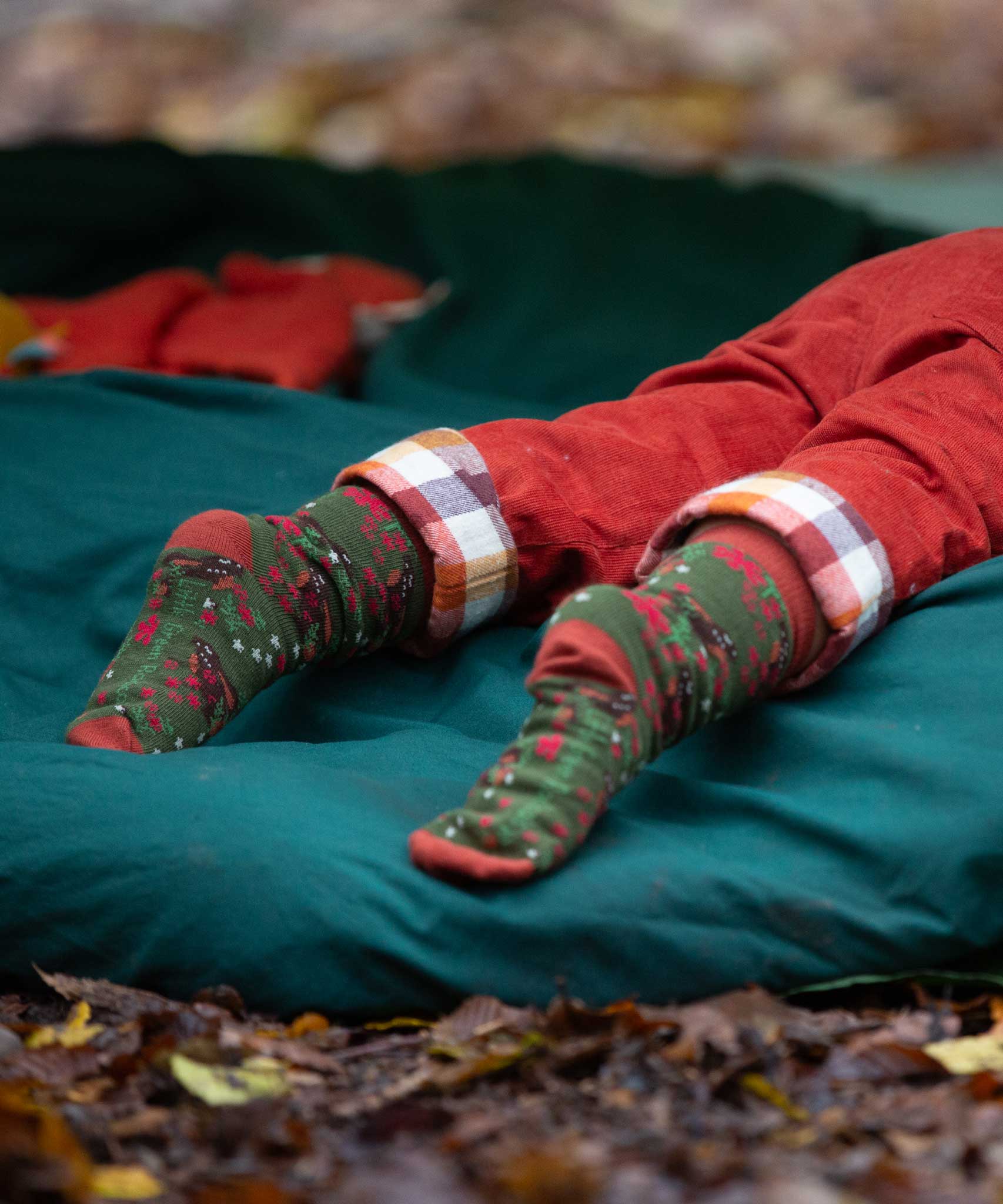 A close up of the winter rabbits design socks on a child's feet. Little Green Radicals Ankle Socks 3 Pack - Winter Rabbits. The organic cotton children's socks are a part of a wide range of organic cotton clothing for children available here at Babipur. 