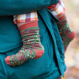 A close up of the winter rabbits design socks on a child's feet. Little Green Radicals Ankle Socks 3 Pack - Winter Rabbits. The organic cotton children's socks are a part of a wide range of organic cotton clothing for children available here at Babipur. 