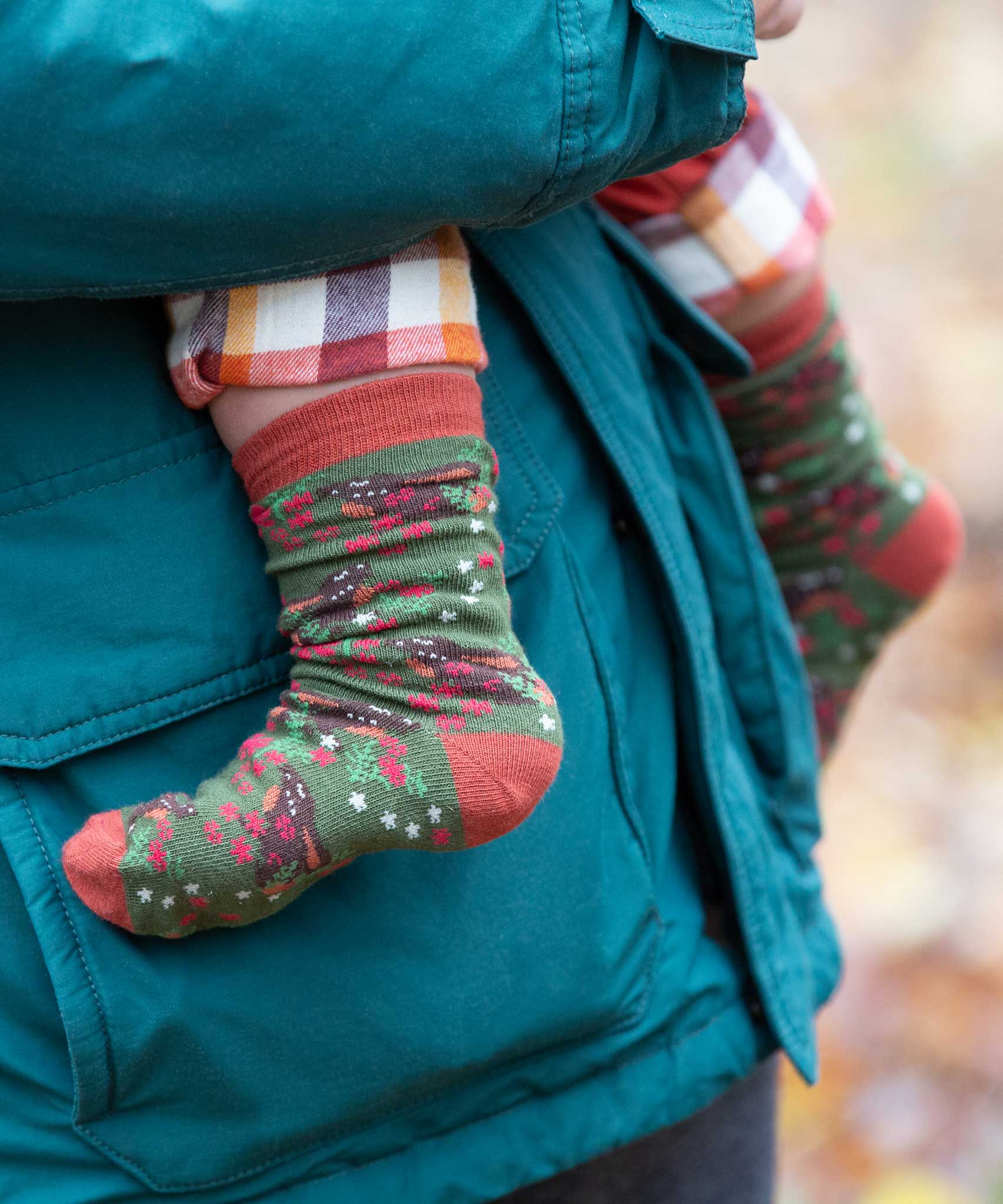 A close up of the winter rabbits design socks on a child's feet. Little Green Radicals Ankle Socks 3 Pack - Winter Rabbits. The organic cotton children's socks are a part of a wide range of organic cotton clothing for children available here at Babipur. 