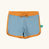 Little Green Radicals hazy blue kids swim shorts with gold waist band and tie and binding. 