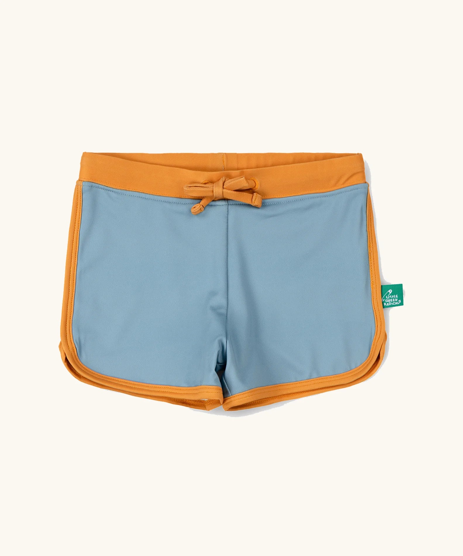 Little Green Radicals hazy blue kids swim shorts with gold waist band and tie and binding. 