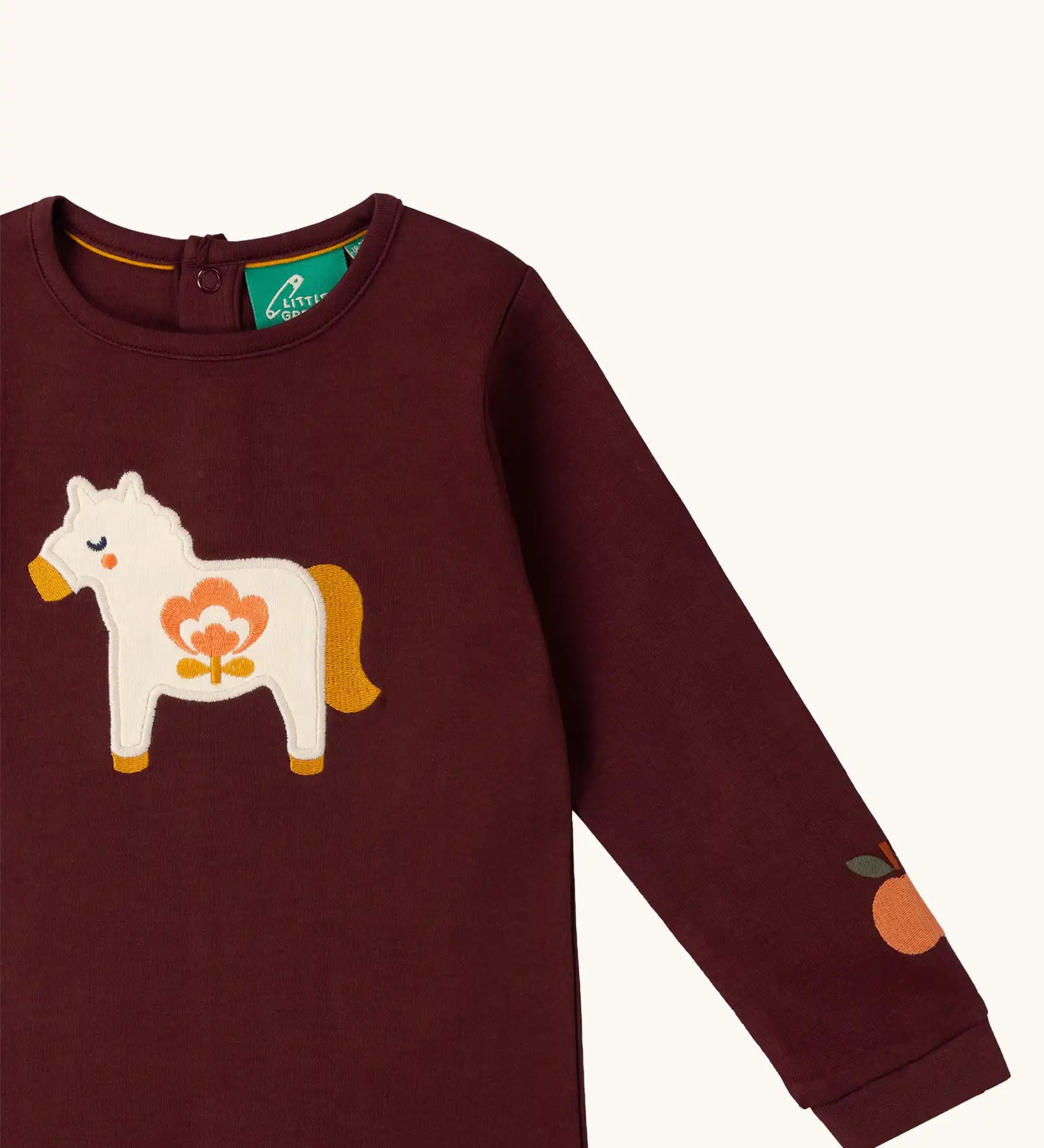 Close up of the horse applique on the front of the Little Green Radicals kids brown horse organic cotton long sleeve top.
