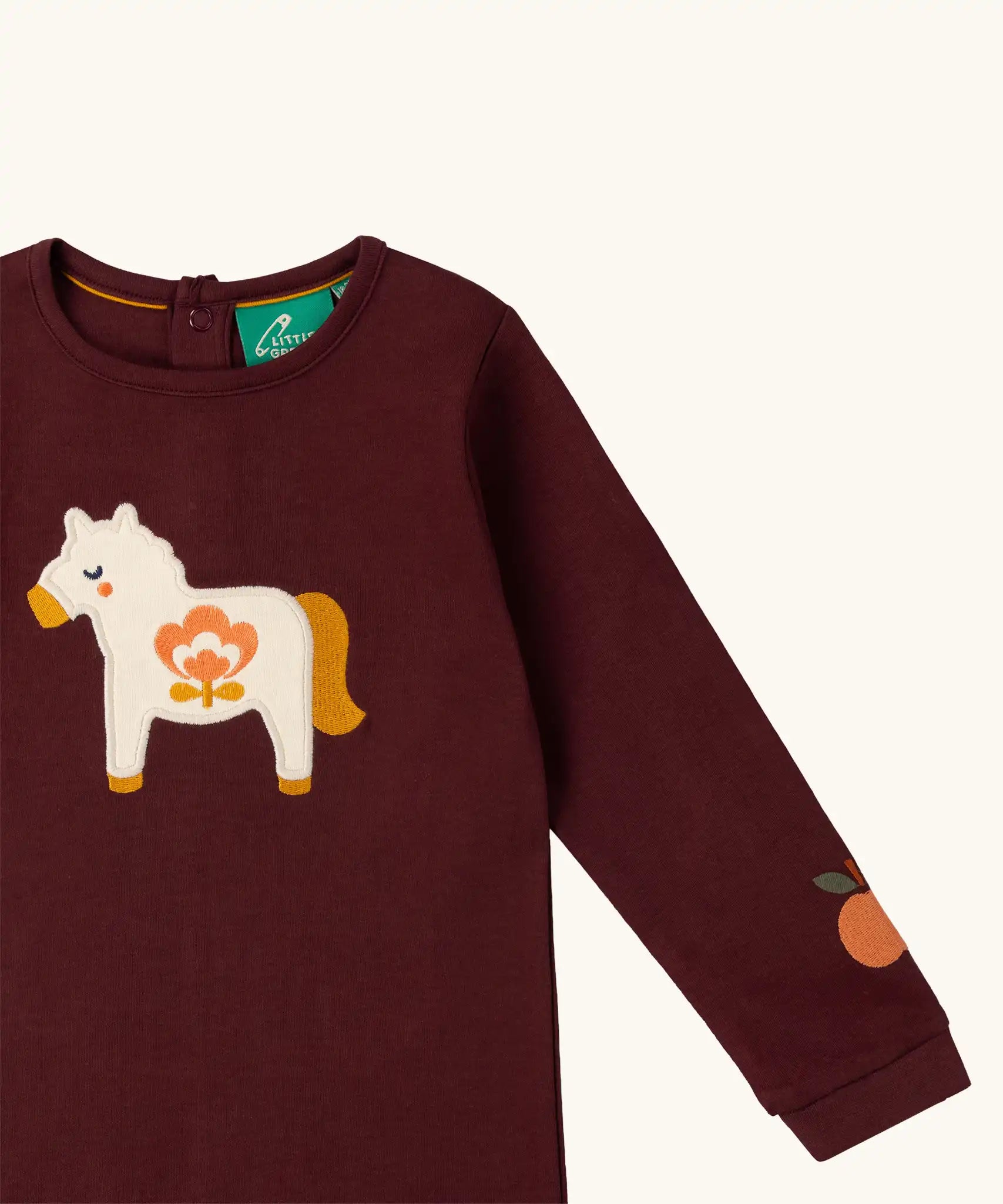 Close up of the horse applique on the front of the Little Green Radicals kids brown horse organic cotton long sleeve top.