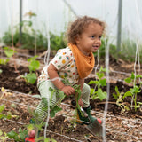 Little Green Radicals vintage style rainbows organic cotton t-shirt & jogger playset being worn. A repeat pattern top featuring nature themed illustrations with cream rainbow striped trousers.