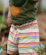 Close up of the waist tie on the Little Green Radicals children's cream rainbow striped by the sea twill shorts being worn. 