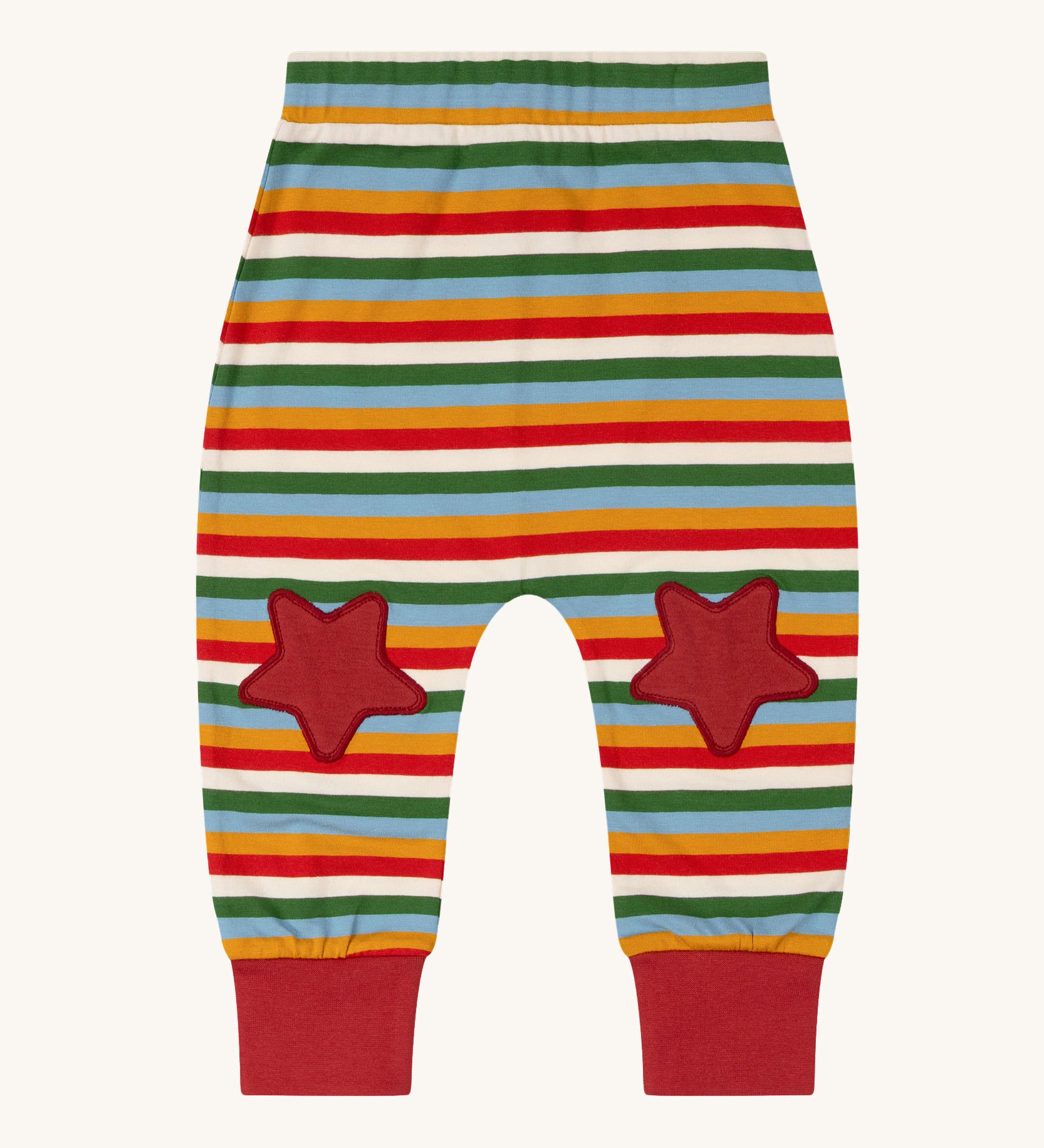 Little Green Radicals Kids' Knee Patch Joggers with Rainbow Striped. The knee patches are red stars. These organic cotton trousers are past of a wide range of children's clothing available at Babipur. 