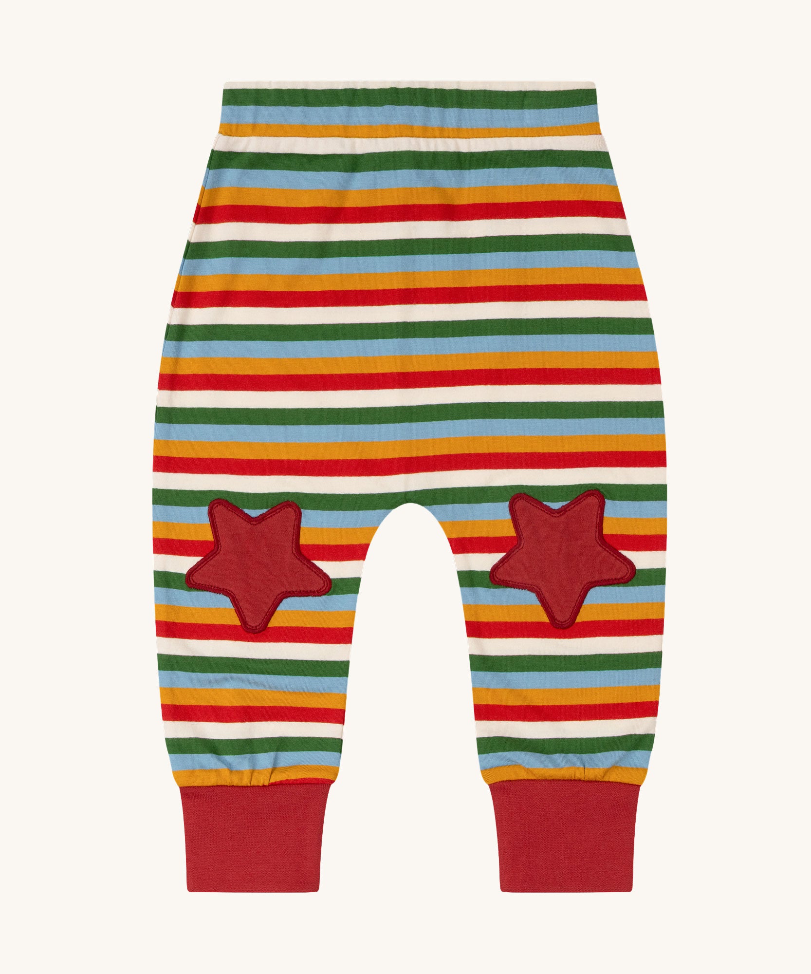 Little Green Radicals Kids' Knee Patch Joggers with Rainbow Striped. The knee patches are red stars. These organic cotton trousers are past of a wide range of children's clothing available at Babipur. 