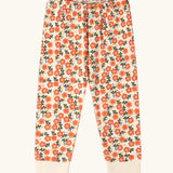 Trousers from the Little Green Radicals petals kids organic cotton pyjamas. Cream coloured pyjamas with an all over repeat pink flower print.