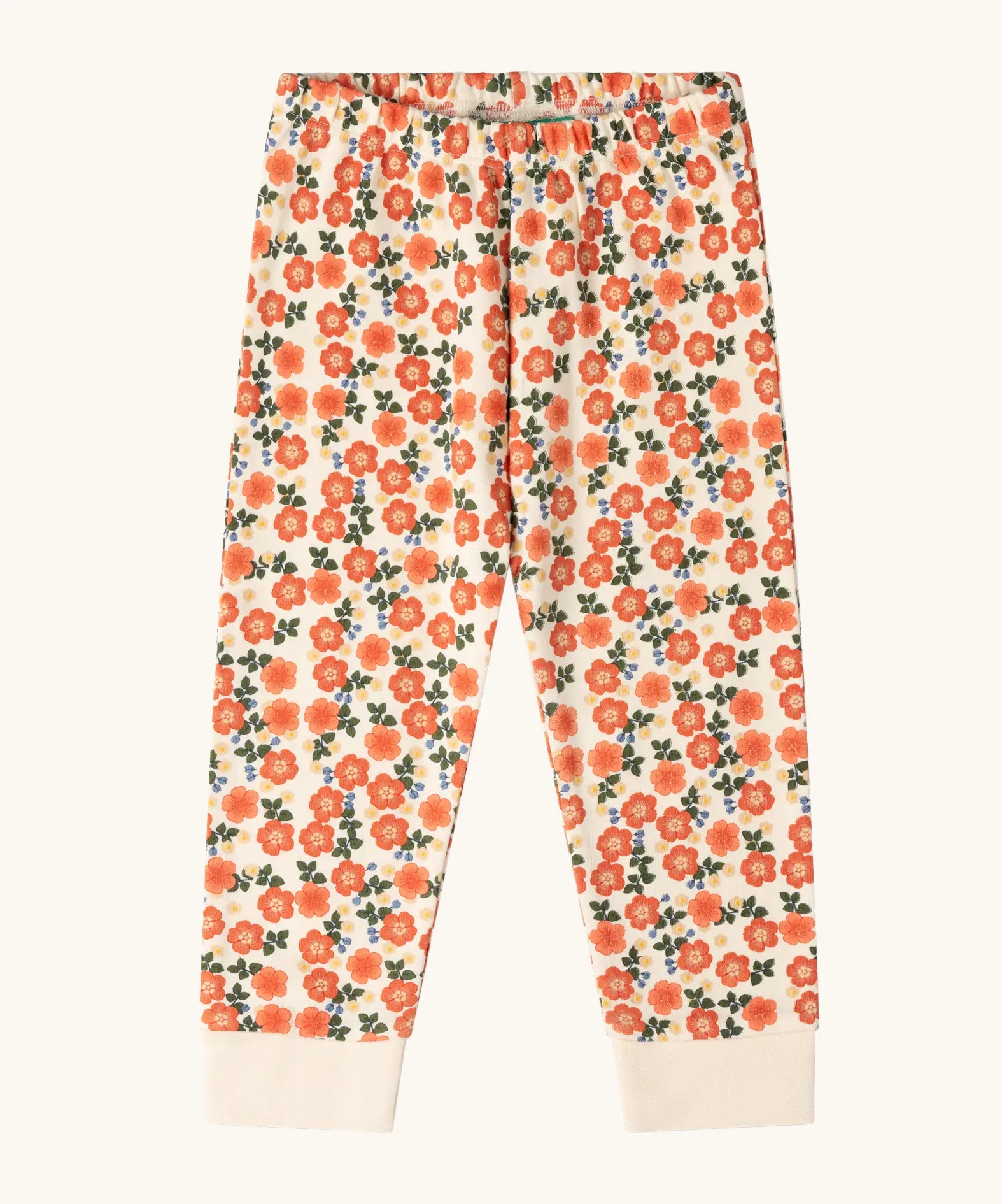 Trousers from the Little Green Radicals petals kids organic cotton pyjamas. Cream coloured pyjamas with an all over repeat pink flower print.