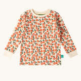 Top from the Little Green Radicals petals kids organic cotton pyjamas. Cream coloured pyjamas with an all over repeat pink flower print.