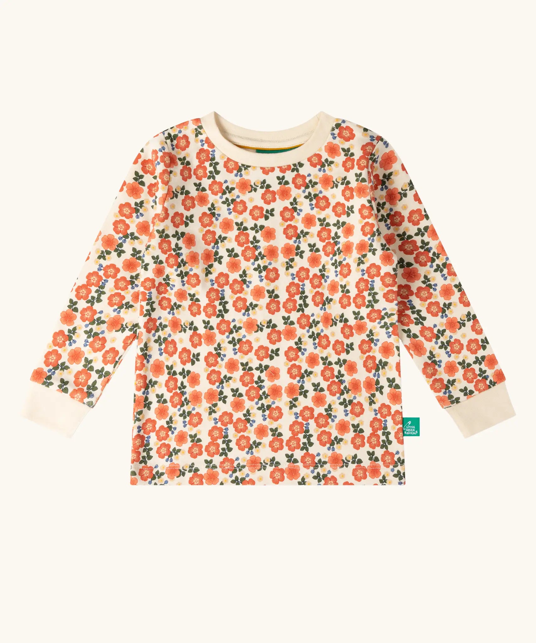 Top from the Little Green Radicals petals kids organic cotton pyjamas. Cream coloured pyjamas with an all over repeat pink flower print.