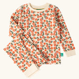 Little Green Radicals petals kids organic cotton pyjamas. Cream coloured pyjamas with an all over repeat pink flower print.