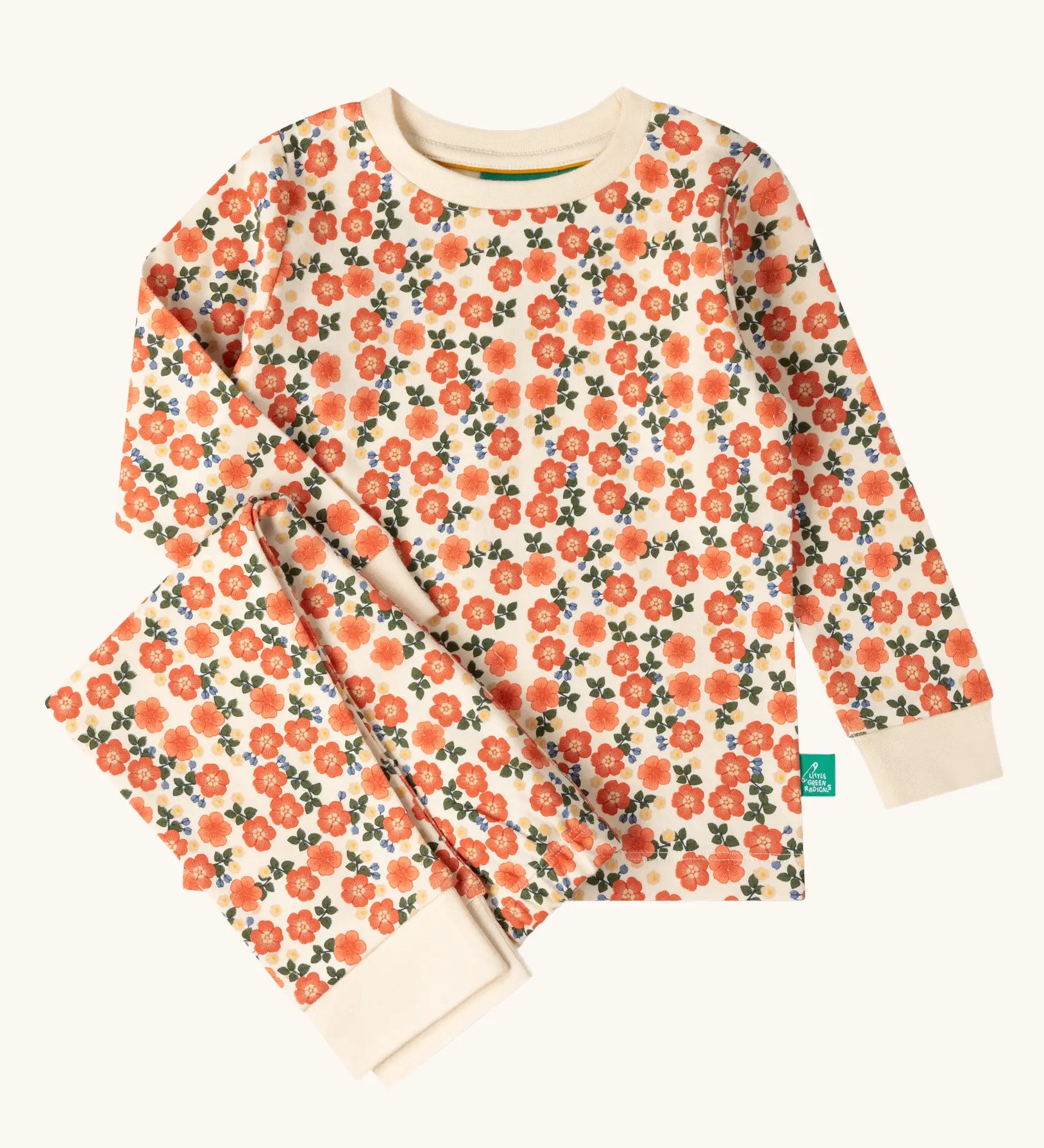 Little Green Radicals petals kids organic cotton pyjamas. Cream coloured pyjamas with an all over repeat pink flower print.