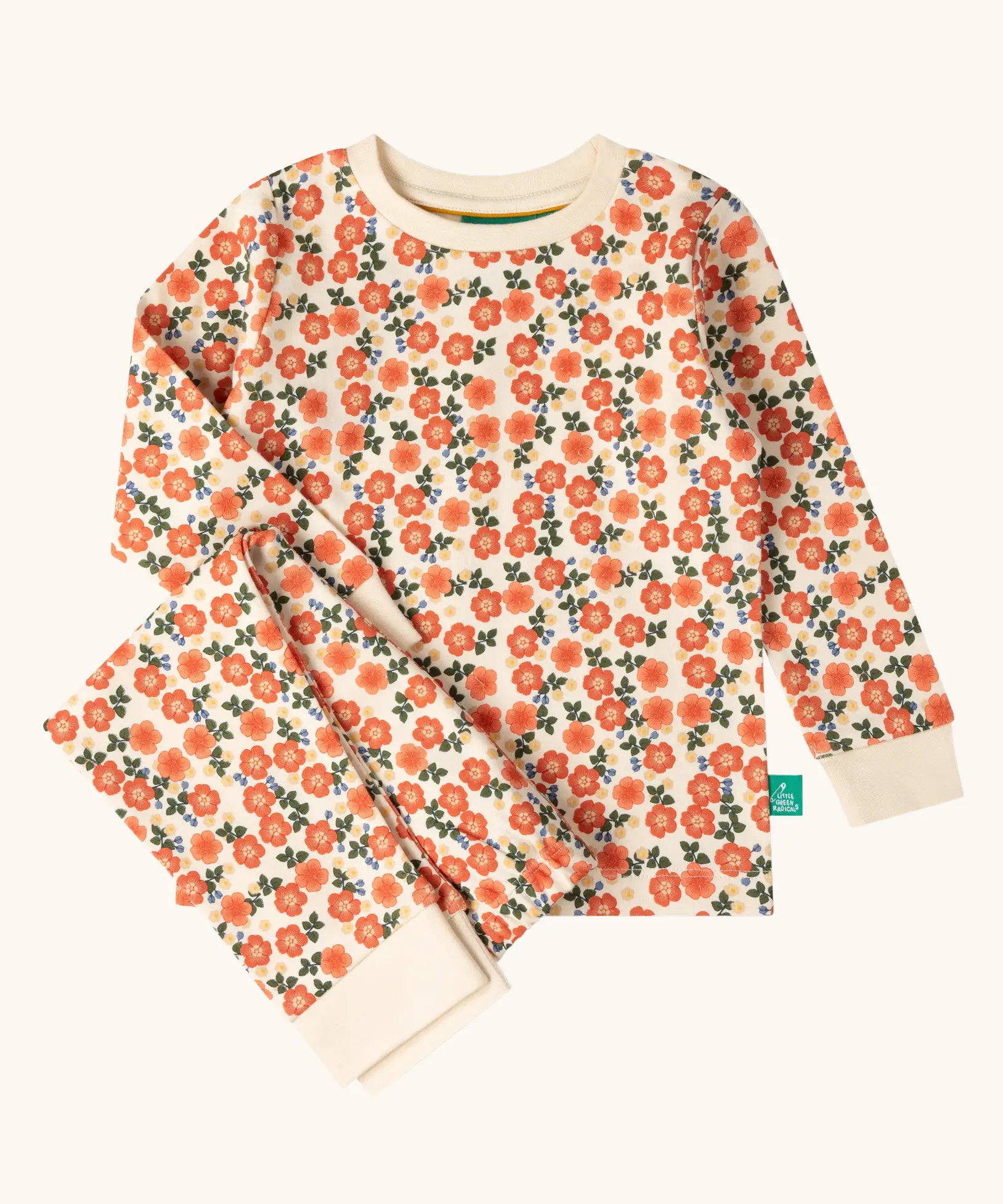 Little Green Radicals petals kids organic cotton pyjamas. Cream coloured pyjamas with an all over repeat pink flower print.