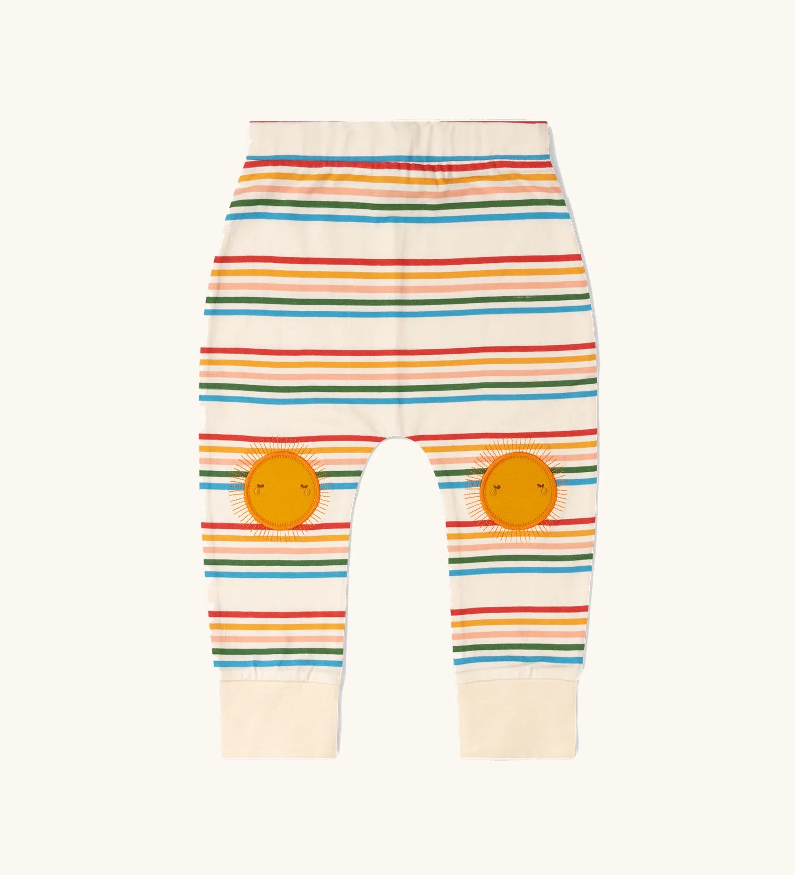 Little Green Radicals cream rainbow striped knee patch organic cotton kids joggers. The sunshine applique knee patches has embroidered details.