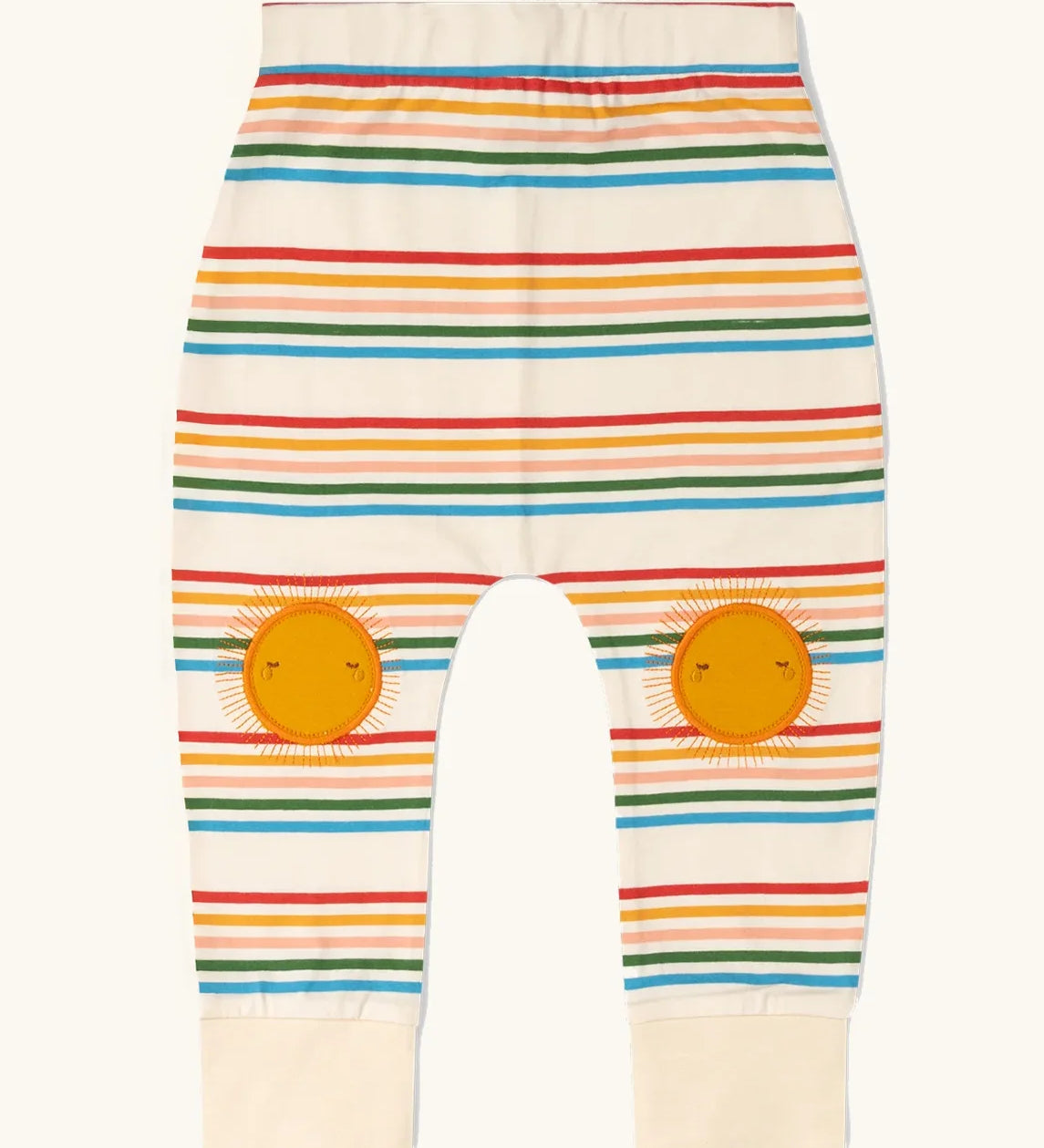 Little Green Radicals cream rainbow striped knee patch organic cotton kids joggers. The sunshine applique knee patches has embroidered details.