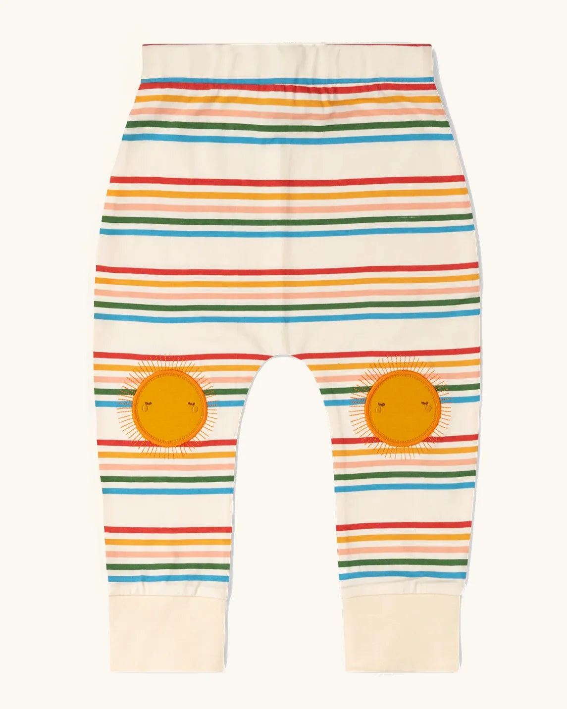 Little Green Radicals cream rainbow striped knee patch organic cotton kids joggers. The sunshine applique knee patches has embroidered details.