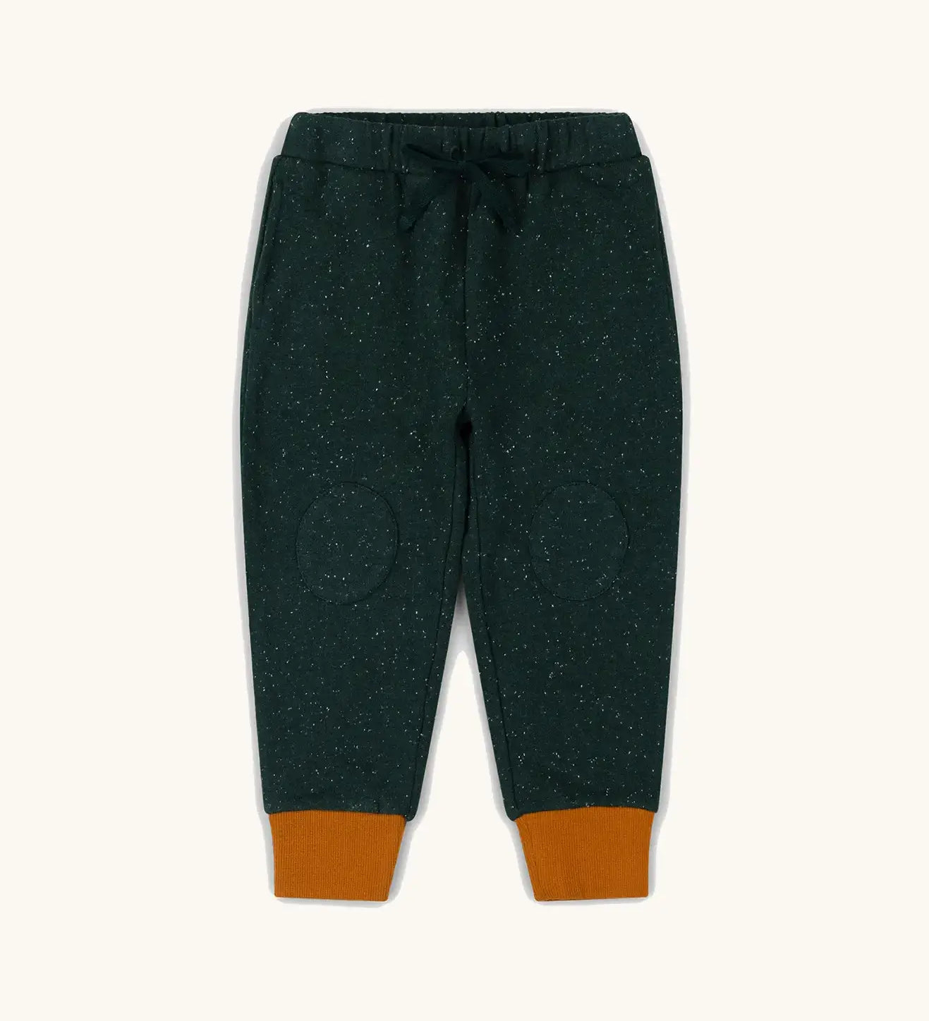 Little Green Radicals cosy organic cotton knee patch joggers in forest green with yellow gold cuffs. 