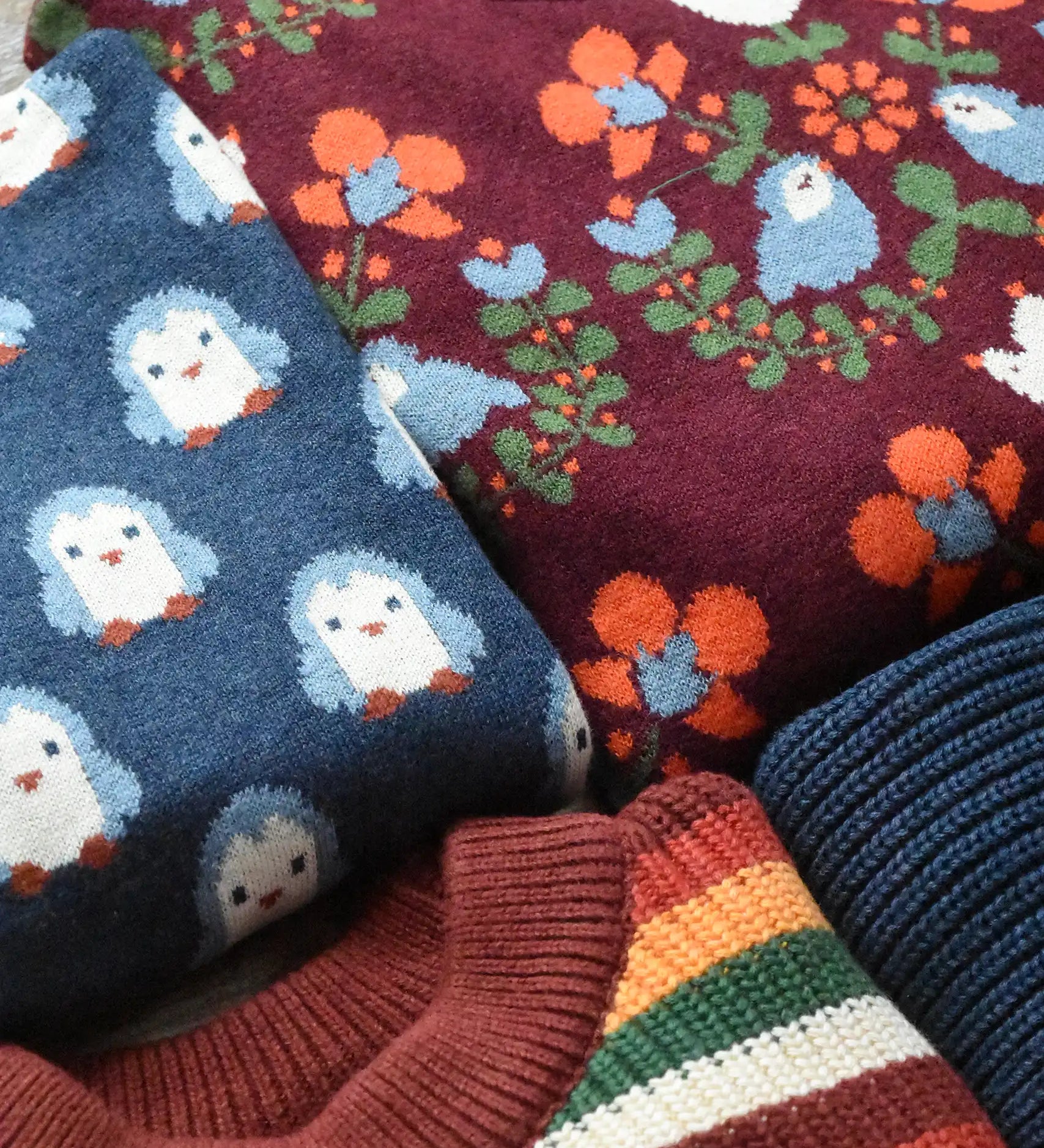 Close up of Little Green Radiclas knitted jumpers shown folded.