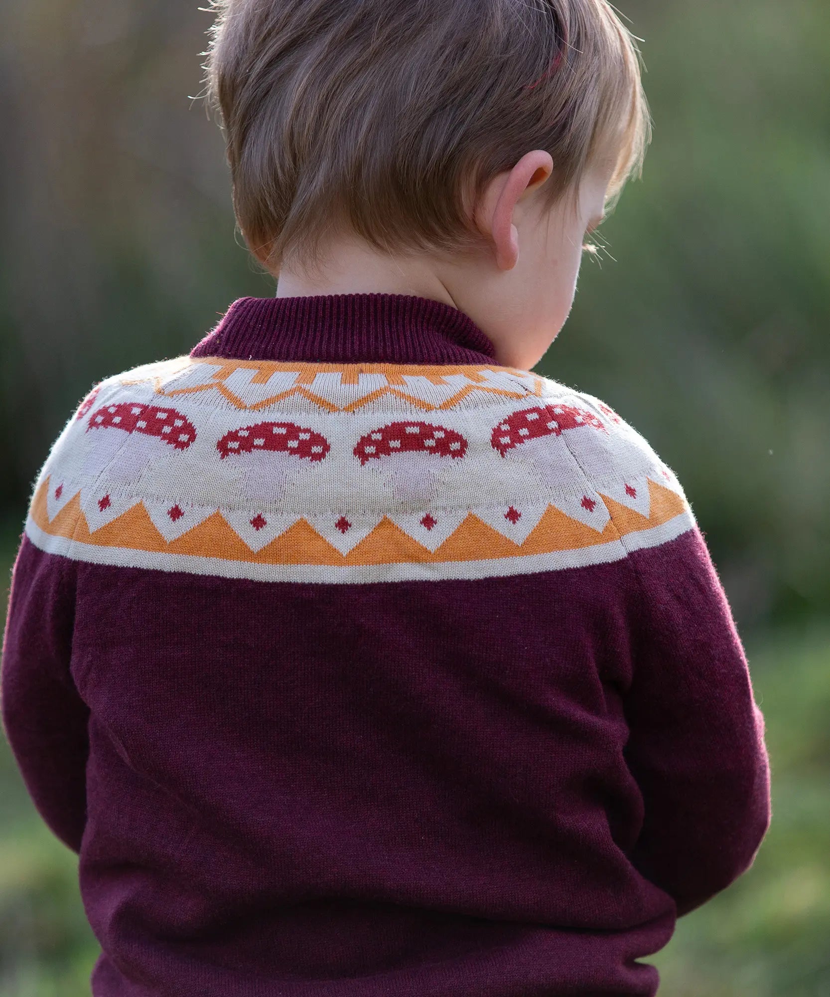Close up of the mushrooms design on the Little Green Radicals knitted organic cotton jumper with a mushroom Fair Isle design.
